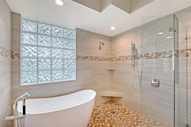 5080 Timber Chase Way, Sarasota, FL 34238 - bathroom featuring a freestanding bath, a tile shower, plenty of natural light, tile walls, and recessed lighting
