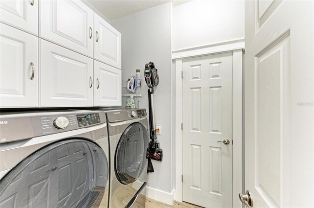 220 39th St NE, Bradenton, FL 34208 - laundry room with cabinet space, washing machine and dryer, and light wood-style flooring
