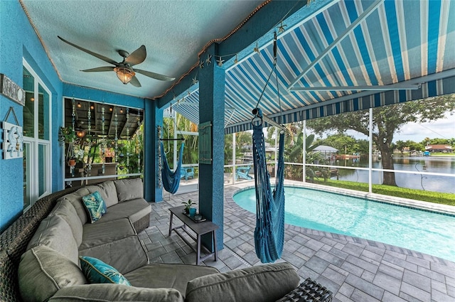 220 39th St NE, Bradenton, FL 34208 - outdoor pool featuring an outdoor hangout area, a ceiling fan, a water view, and a patio
