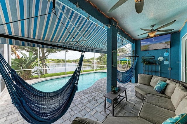 220 39th St NE, Bradenton, FL 34208 - view of pool featuring outdoor lounge area, a water view, a ceiling fan, a patio, and glass enclosure