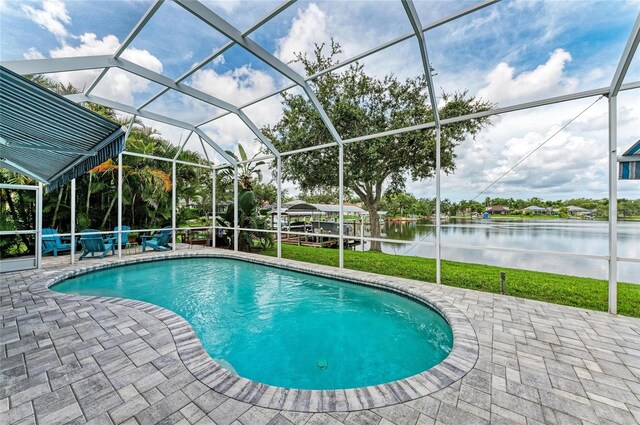 220 39th St NE, Bradenton, FL 34208 - outdoor pool featuring a patio area, a water view, and glass enclosure