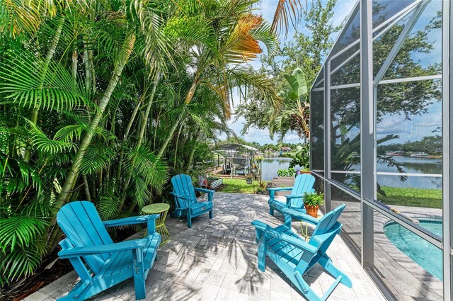 220 39th St NE, Bradenton, FL 34208 - view of patio featuring glass enclosure, an outdoor pool, and a water view