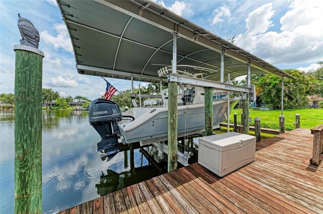 220 39th St NE, Bradenton, FL 34208 - dock area featuring boat lift, a water view, and a yard