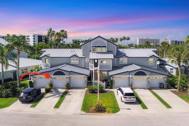 1240 Siesta Bayside Dr Unit 1240C, Sarasota, FL 34242 - view of front of house with driveway and a metal roof