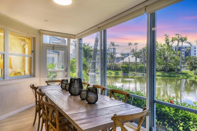1240 Siesta Bayside Dr Unit 1240C, Sarasota, FL 34242 - sunroom / solarium with a water view and wood finished floors