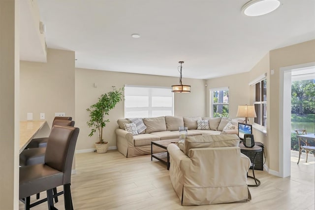 1240 Siesta Bayside Dr Unit 1240C, Sarasota, FL 34242 - living room featuring healthy amount of natural light and light wood finished floors