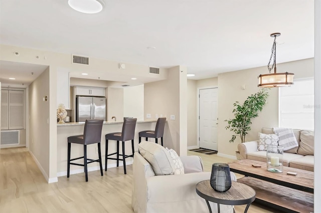 1240 Siesta Bayside Dr Unit 1240C, Sarasota, FL 34242 - living room featuring light wood-style flooring and recessed lighting