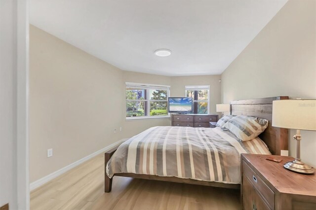 1240 Siesta Bayside Dr Unit 1240C, Sarasota, FL 34242 - bedroom featuring light wood-style floors and baseboards