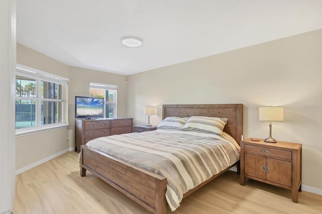 1240 Siesta Bayside Dr Unit 1240C, Sarasota, FL 34242 - bedroom featuring baseboards and light wood-type flooring