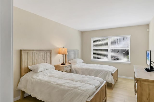 1240 Siesta Bayside Dr Unit 1240C, Sarasota, FL 34242 - bedroom with baseboards and light wood-style flooring