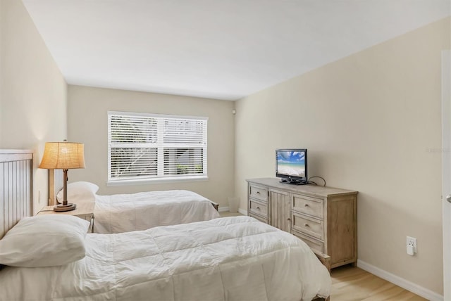 1240 Siesta Bayside Dr Unit 1240C, Sarasota, FL 34242 - bedroom featuring baseboards and light wood-style floors