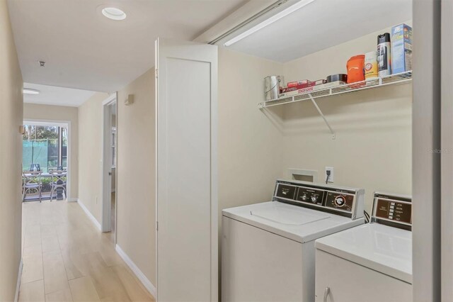 1240 Siesta Bayside Dr Unit 1240C, Sarasota, FL 34242 - washroom with washer and dryer and light wood-type flooring