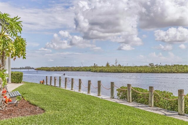 1240 Siesta Bayside Dr Unit 1240C, Sarasota, FL 34242 - dock area featuring a water view and a yard
