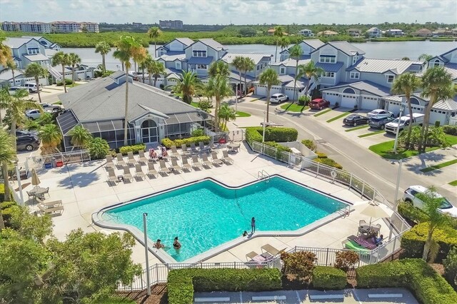 1240 Siesta Bayside Dr Unit 1240C, Sarasota, FL 34242 - community pool featuring a residential view and a patio