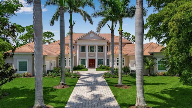 550 Dove Pointe, Osprey, FL 34229 - greek revival inspired property featuring stucco siding, a front lawn, and a tiled roof