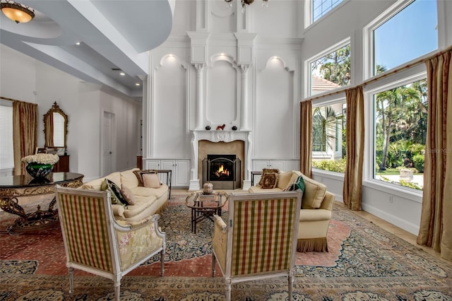 550 Dove Pointe, Osprey, FL 34229 - living room with a towering ceiling, a premium fireplace, and recessed lighting