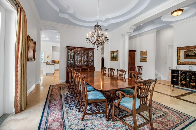 550 Dove Pointe, Osprey, FL 34229 - dining space with a raised ceiling, ornamental molding, a towering ceiling, a chandelier, and inlaid floor details