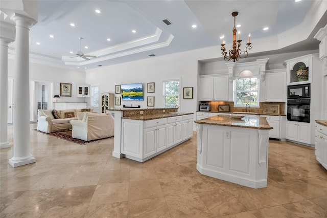 550 Dove Pointe, Osprey, FL 34229 - kitchen featuring black appliances, a center island, a raised ceiling, plenty of natural light, and ornamental molding