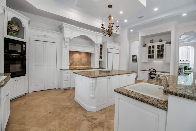 550 Dove Pointe, Osprey, FL 34229 - kitchen with black appliances, a kitchen island, tasteful backsplash, glass insert cabinets, and recessed lighting