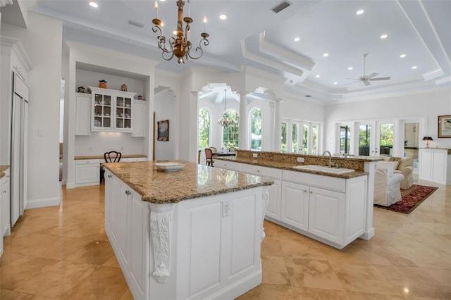 550 Dove Pointe, Osprey, FL 34229 - kitchen featuring a large island, a tray ceiling, ceiling fan, white cabinets, and recessed lighting