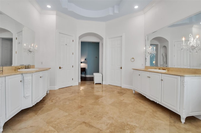 550 Dove Pointe, Osprey, FL 34229 - bathroom featuring a chandelier, two vanities, crown molding, and recessed lighting