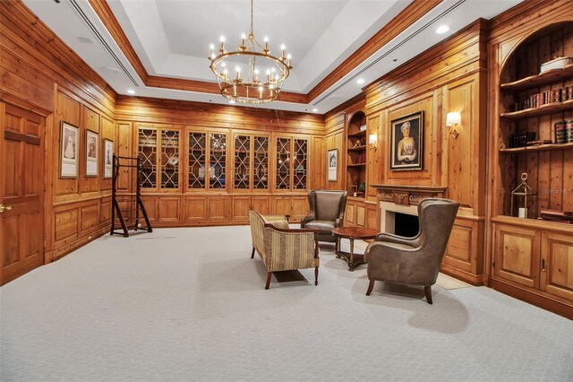 550 Dove Pointe, Osprey, FL 34229 - living area featuring wooden walls, a chandelier, light carpet, built in features, and crown molding