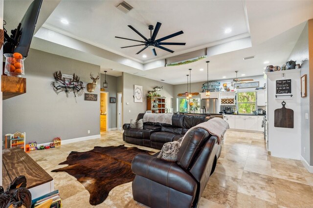 15780 Wilson Rd, Sarasota, FL 34240 - living room featuring a ceiling fan, ornamental molding, recessed lighting, a tray ceiling, and light tile patterned flooring