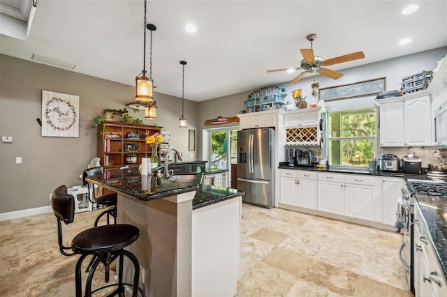 15780 Wilson Rd, Sarasota, FL 34240 - kitchen featuring stainless steel appliances, plenty of natural light, a ceiling fan, white cabinets, and recessed lighting