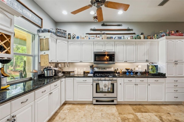15780 Wilson Rd, Sarasota, FL 34240 - kitchen featuring appliances with stainless steel finishes, white cabinets, a ceiling fan, dark stone countertops, and recessed lighting