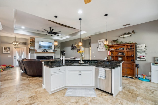 15780 Wilson Rd, Sarasota, FL 34240 - kitchen featuring stainless steel dishwasher, ceiling fan, a fireplace, open floor plan, and a raised ceiling