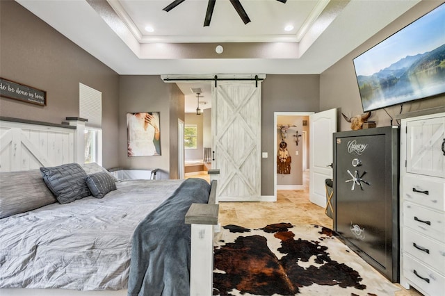 15780 Wilson Rd, Sarasota, FL 34240 - bedroom with a barn door, a tray ceiling, crown molding, and a ceiling fan