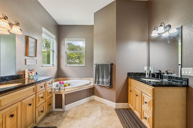15780 Wilson Rd, Sarasota, FL 34240 - full bathroom featuring a textured wall, two vanities, and a bath