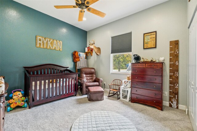 15780 Wilson Rd, Sarasota, FL 34240 - bedroom featuring a crib, carpet flooring, and ceiling fan