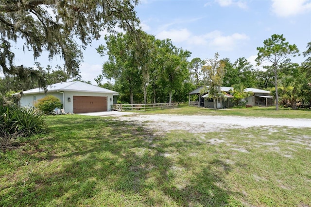 15780 Wilson Rd, Sarasota, FL 34240 - view of yard with driveway and a garage