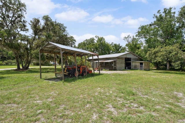 15780 Wilson Rd, Sarasota, FL 34240 - view of grassy yard featuring a detached carport and an outbuilding