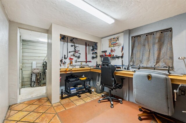 15780 Wilson Rd, Sarasota, FL 34240 - home office featuring a workshop area and a textured ceiling