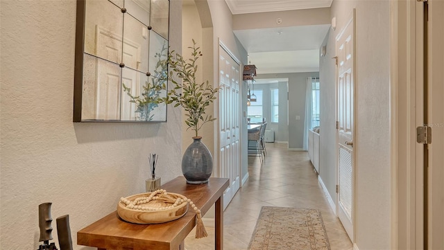 1030 Tidewater Shores Loop Unit 307, Bradenton, FL 34208 - corridor featuring a textured wall, light tile patterned flooring, and ornamental molding