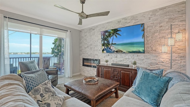 1030 Tidewater Shores Loop Unit 307, Bradenton, FL 34208 - living area featuring a large fireplace, a ceiling fan, ornamental molding, and a water view