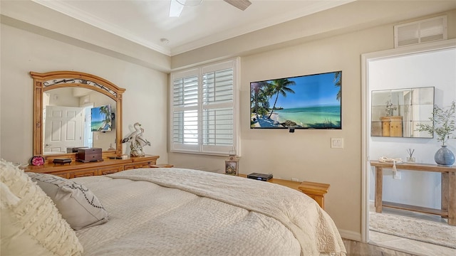 1030 Tidewater Shores Loop Unit 307, Bradenton, FL 34208 - bedroom with wood finished floors, crown molding, and ceiling fan