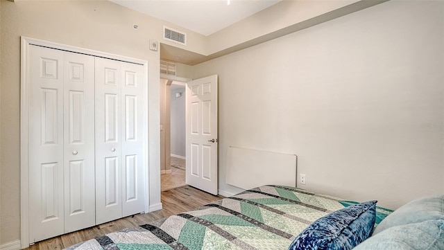 1030 Tidewater Shores Loop Unit 307, Bradenton, FL 34208 - bedroom featuring wood finished floors and a closet
