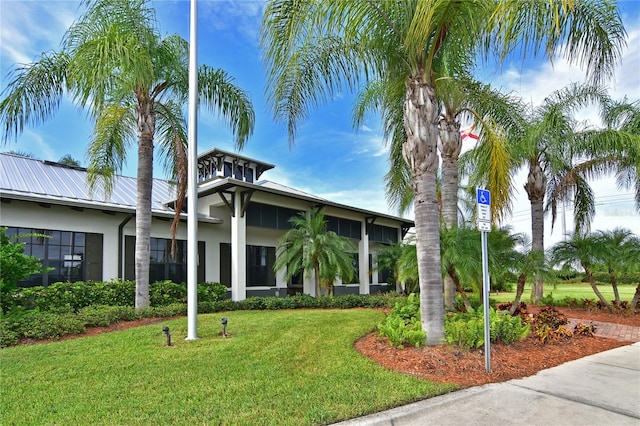 1030 Tidewater Shores Loop Unit 307, Bradenton, FL 34208 - view of front of property featuring a front yard, stucco siding, and a metal roof