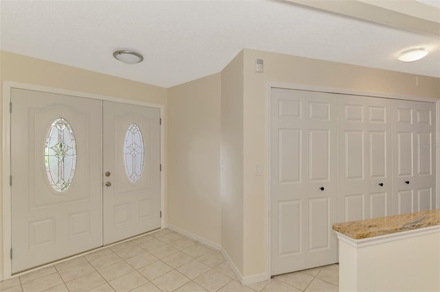 5124 Palm Aire Dr, Sarasota, FL 34243 - foyer with light tile patterned floors and baseboards