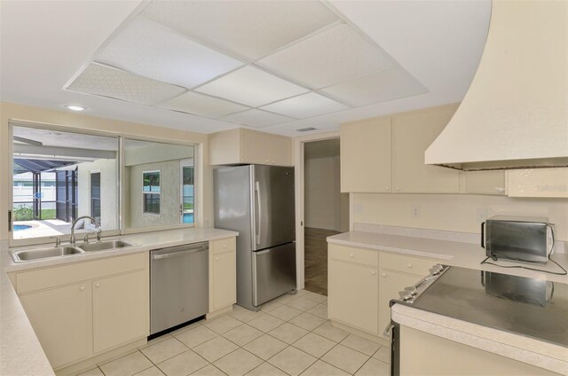 5124 Palm Aire Dr, Sarasota, FL 34243 - kitchen featuring appliances with stainless steel finishes, premium range hood, and light countertops
