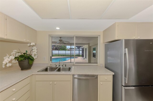 5124 Palm Aire Dr, Sarasota, FL 34243 - kitchen featuring stainless steel appliances, light countertops, ceiling fan, and cream cabinets