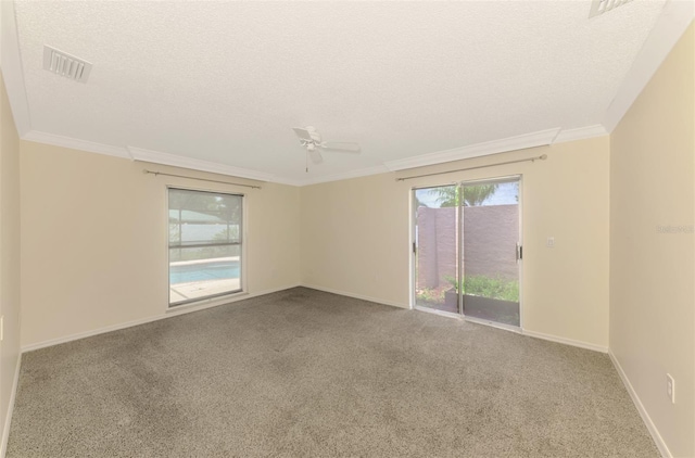 5124 Palm Aire Dr, Sarasota, FL 34243 - spare room with carpet, a textured ceiling, a ceiling fan, and crown molding