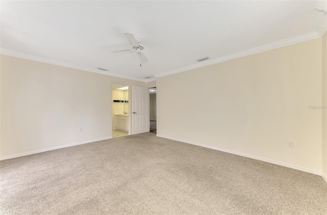 5124 Palm Aire Dr, Sarasota, FL 34243 - spare room with ceiling fan, light colored carpet, and crown molding