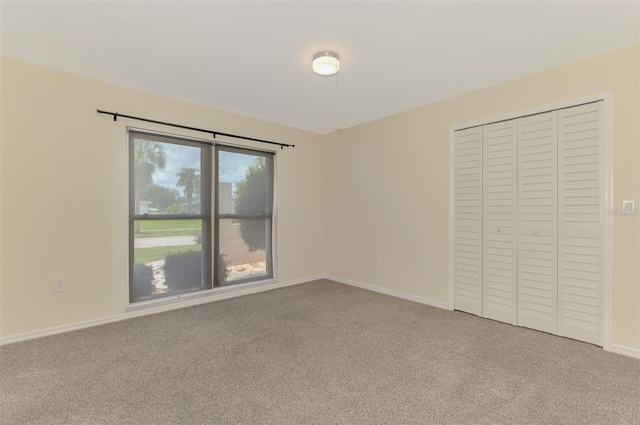 5124 Palm Aire Dr, Sarasota, FL 34243 - unfurnished bedroom featuring carpet flooring and a closet
