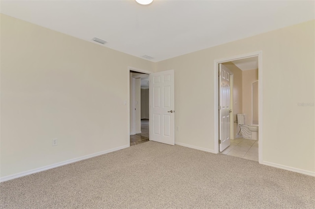5124 Palm Aire Dr, Sarasota, FL 34243 - unfurnished bedroom featuring light carpet and ensuite bathroom