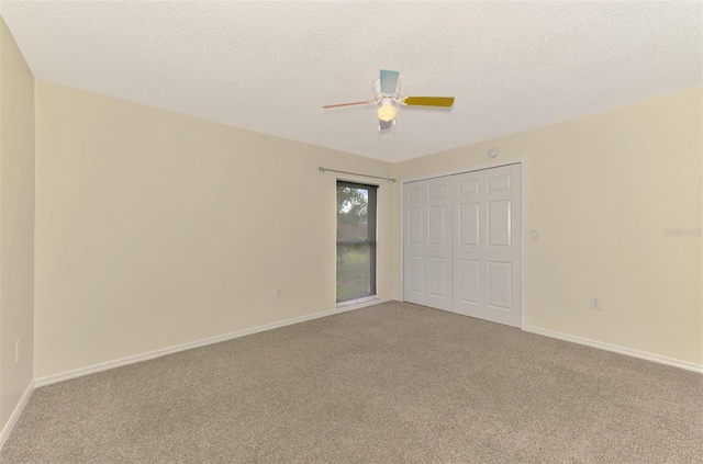 5124 Palm Aire Dr, Sarasota, FL 34243 - unfurnished bedroom featuring carpet floors, a closet, a ceiling fan, and a textured ceiling