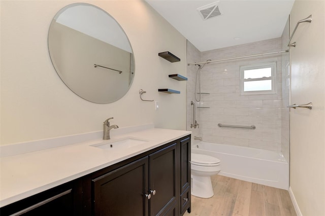 5124 Palm Aire Dr, Sarasota, FL 34243 - full bathroom with vanity, wood finished floors, and shower / tub combination